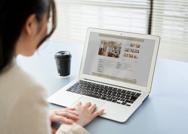 A woman looking at a property listing online.