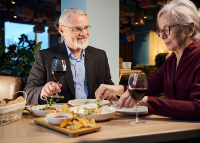 A couple enjoying a meal in a restaurant together.