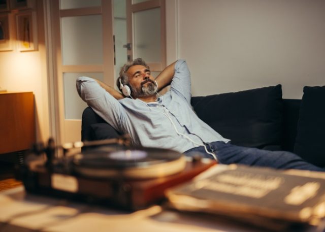 A man relaxing while listening to music.