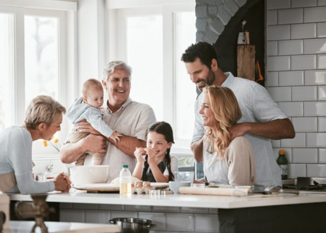 Three generations of family cooking in the kitchen