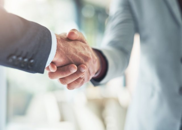 Two people shaking hands.