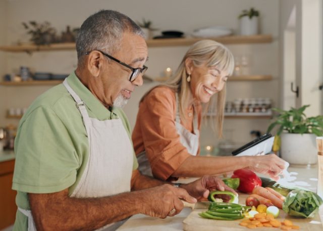 A couple cooking a meal together.